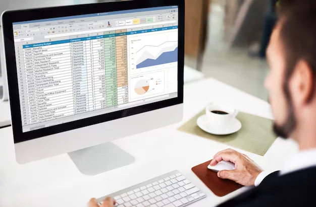 Man in front of a screen with Excel open